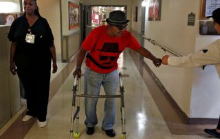 Nursing home resident walking down hall
