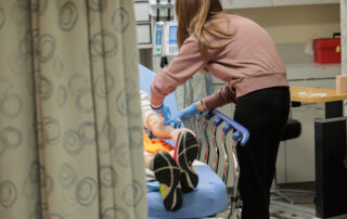 A provider treats a patient at San Leandro Hospital.